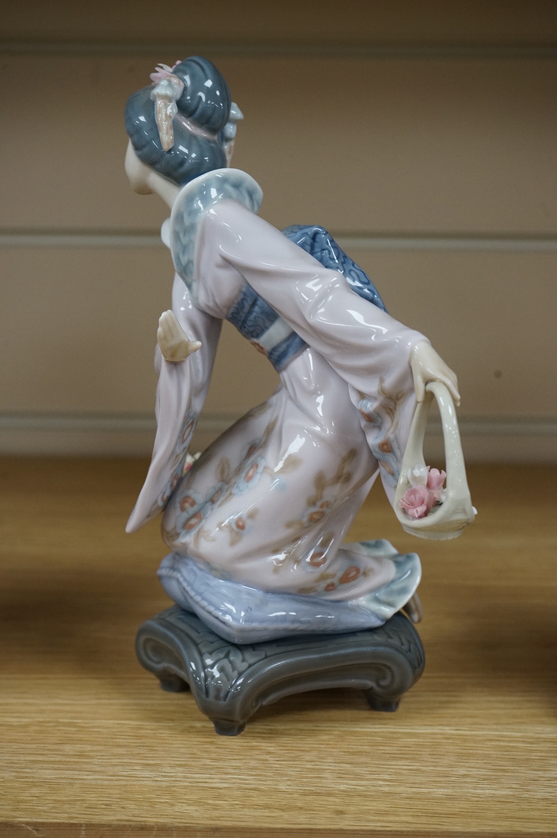 Three Lladro models of seated Geisha. Tallest 23cm